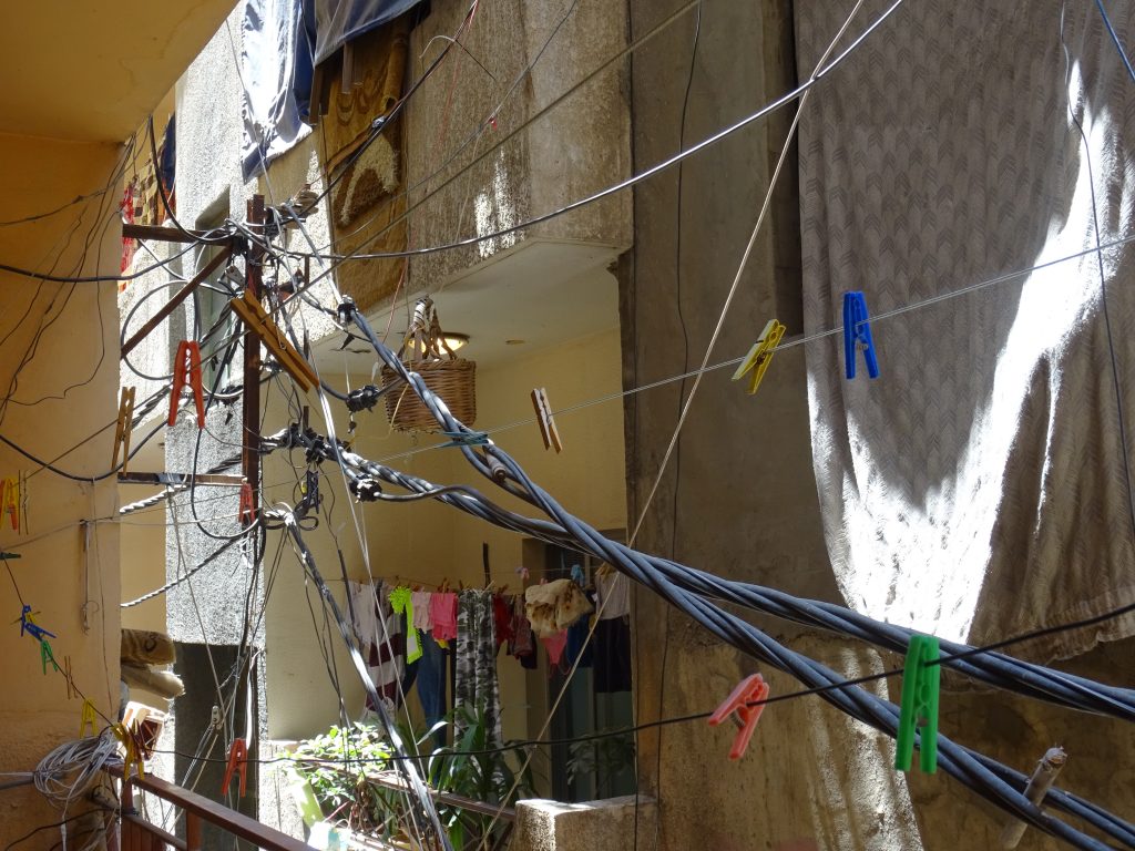Making it work: electricity cables and clothes lines in Baddawi refugee camp, North Lebanon. Photo by Elena Fiddian-Qasmiyeh